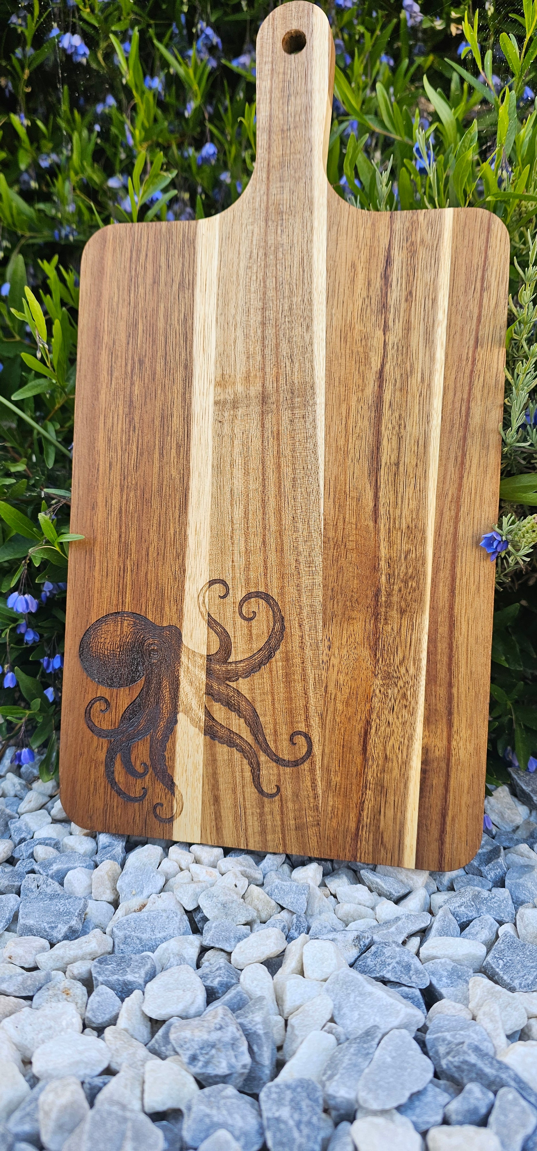 Wooden cutting board with an engraved design on a natural background