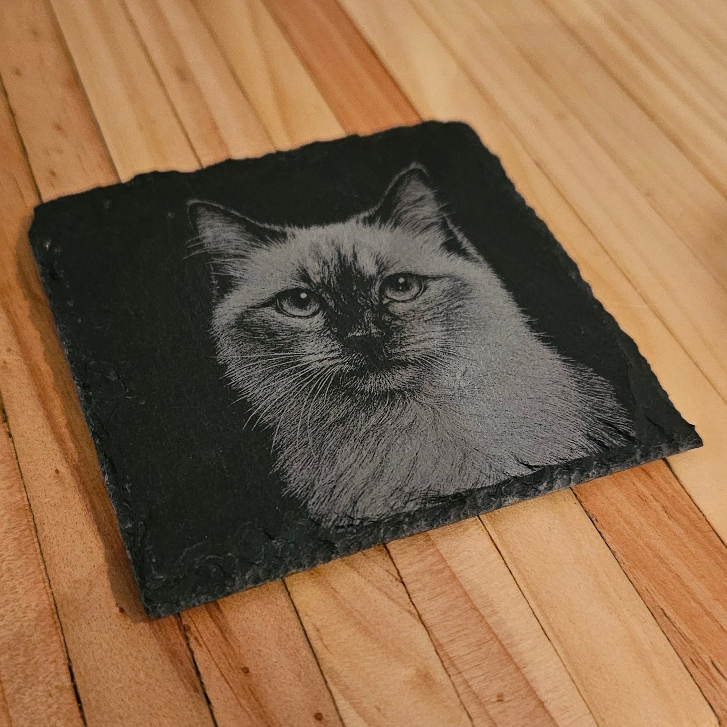 Black patch with a cat design on a wooden surface